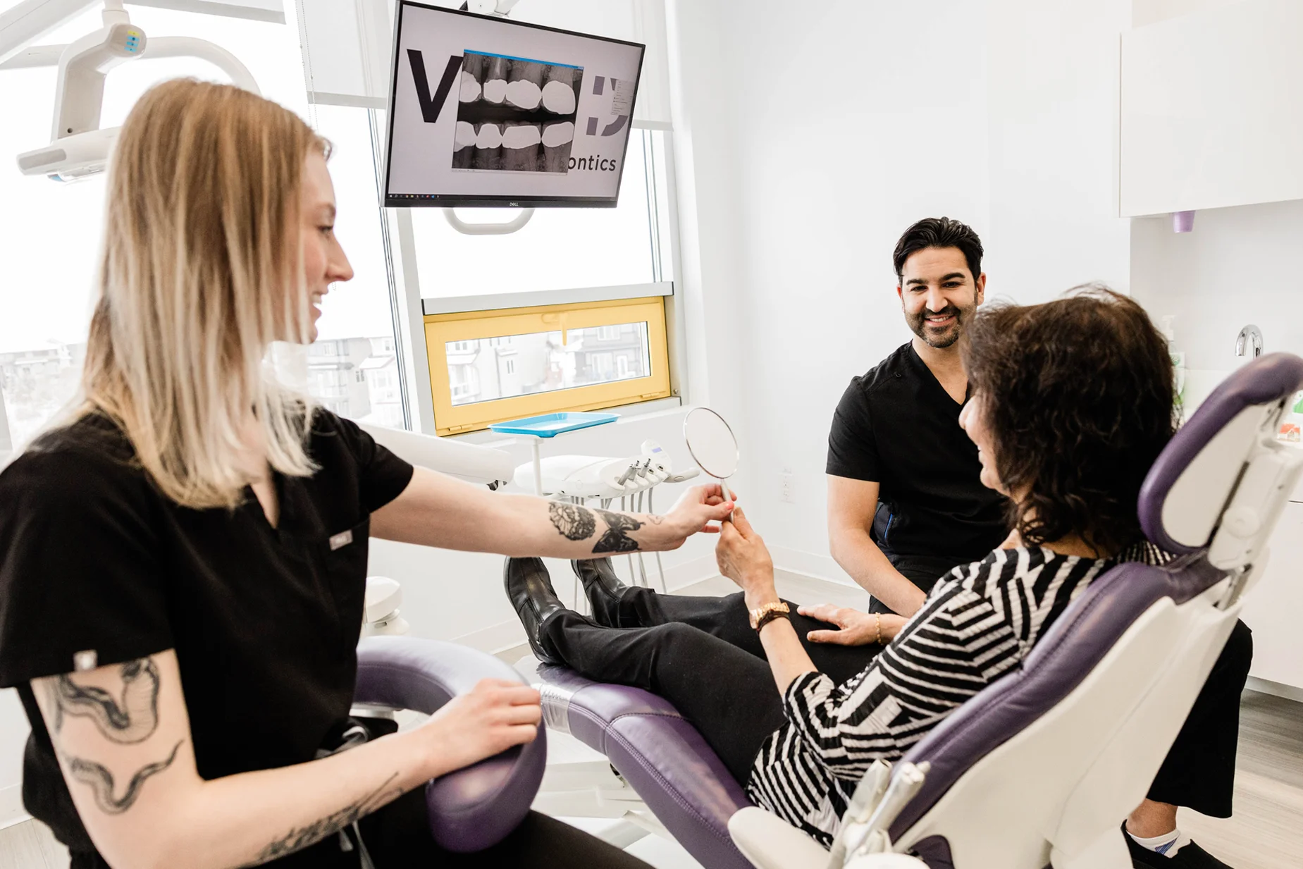 Dental team caring for a patient in the treatment chair at Vivid Specialized Dentistry