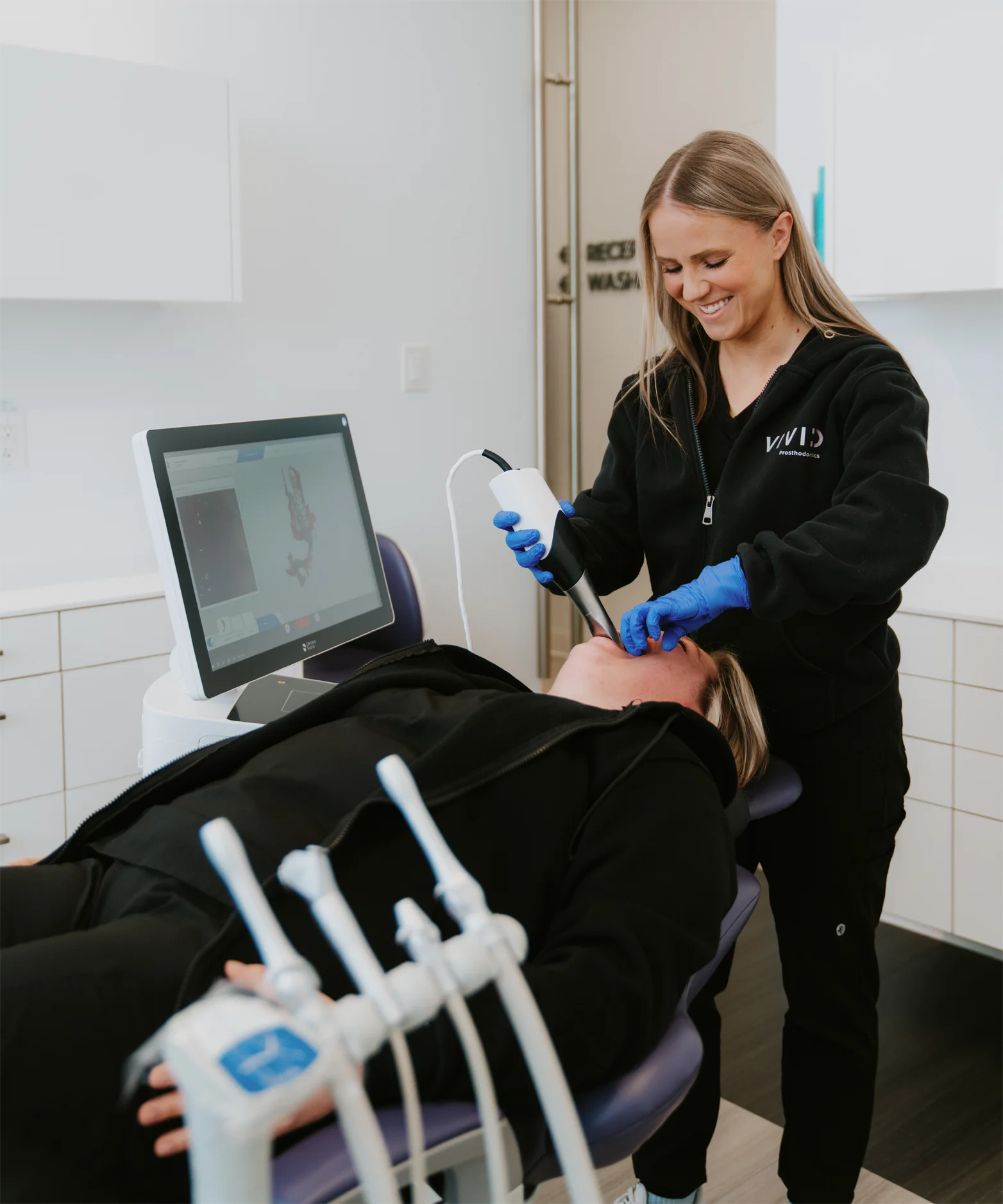 Team member taking a 3D Primescan scan of a patient at Vivid Specialized Dentistry