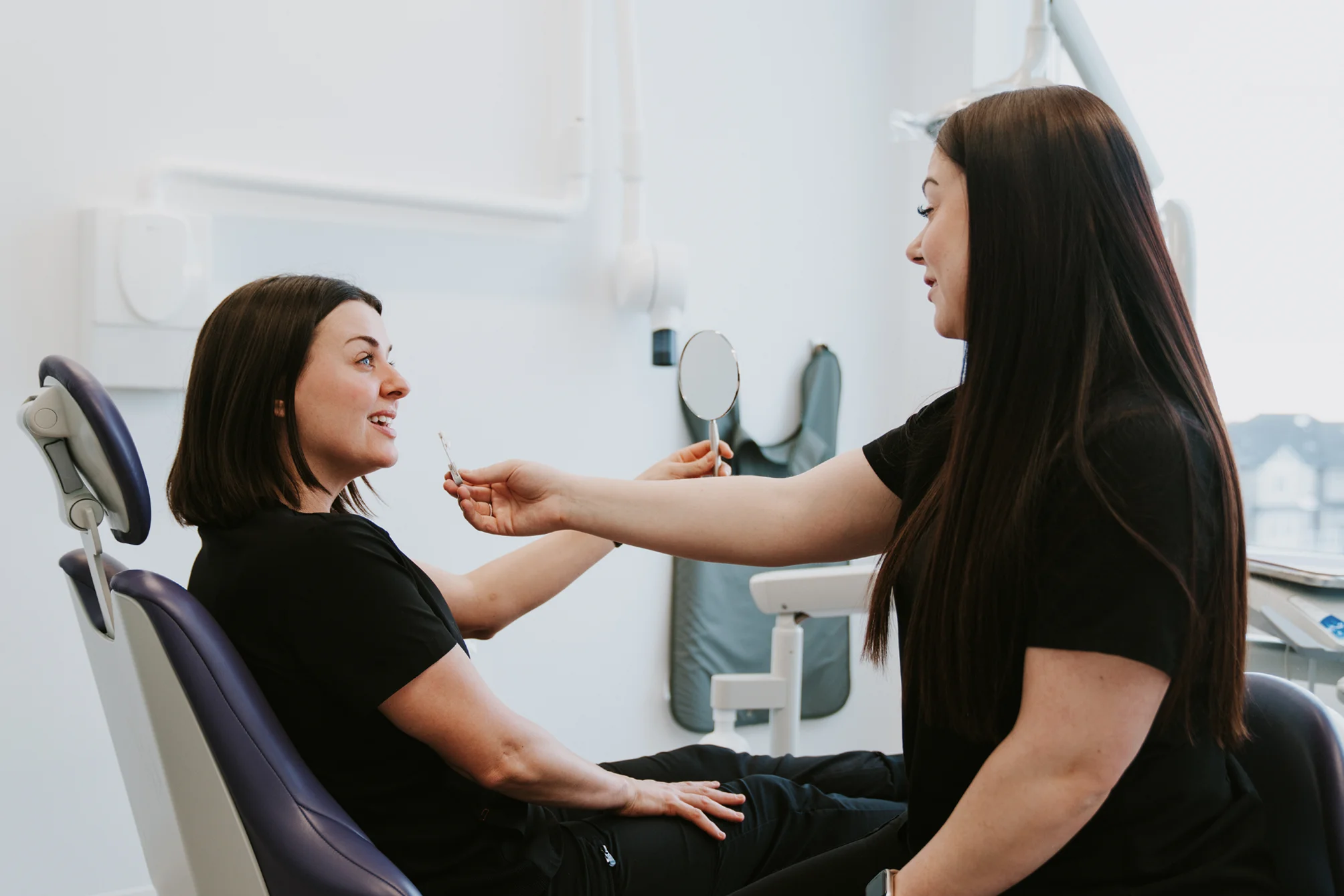 Specialist talking with a patient in a treatment chair at Vivid Specialized Dentistry