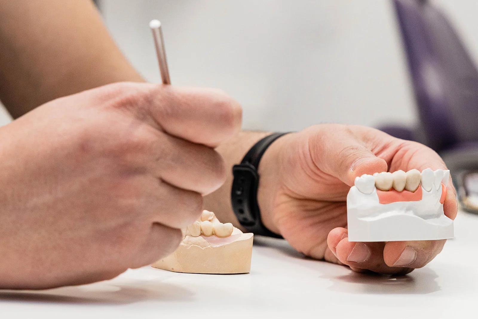 Specialist reviewing a dental model in the Vivid Specialized Dentistry lab